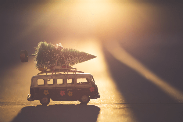 A Christmas present of a vw van with a Christmas tree on top. The photo is in relation to holiday blog post ideas post.