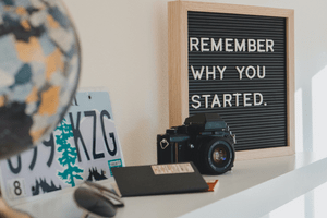 photo of diverse lifestyle objects e.g. a camera, a board with letters "Remember why you started" and more. This blog post is in relation to
personal development goals