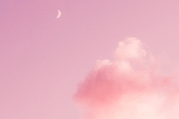 Pink sky with a few clouds regarding a blog post about powerful manifestation quotes