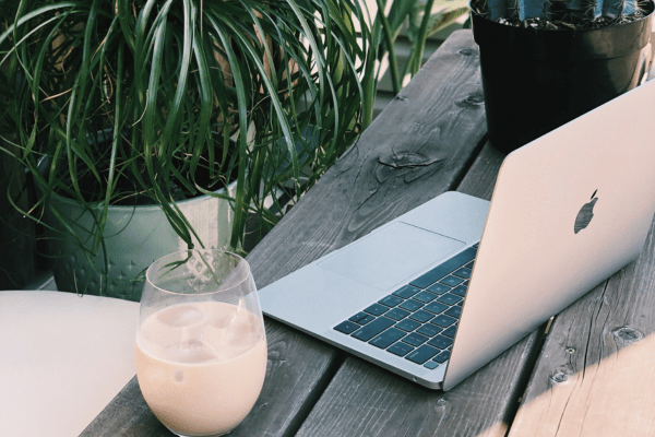 Image of a pc and cappuccino outside showing remote working. Image related to a blog post about affiliate marketing is it worth it
