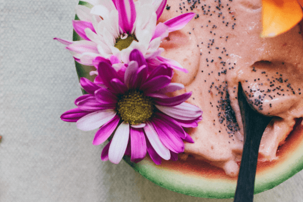 Half watermelon with cream and flowers. Social media content ideas for summer