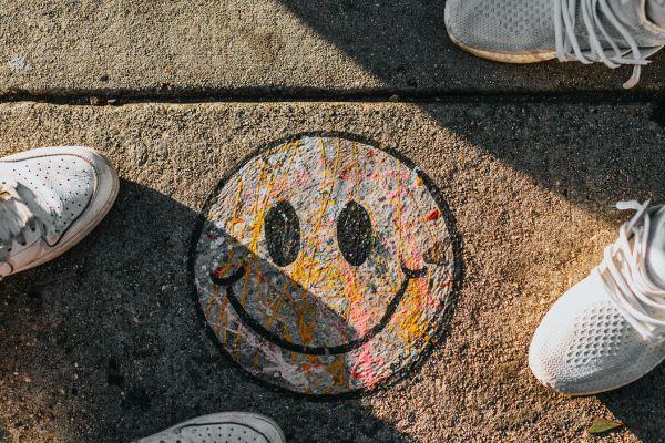 smiley face surrounded by friends shoes. The photo is in relation what are positive influences