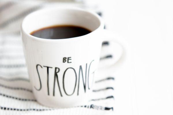 inspirational coffee mug with title Strong in relation to blog post about quotes to give you strength when feeling low