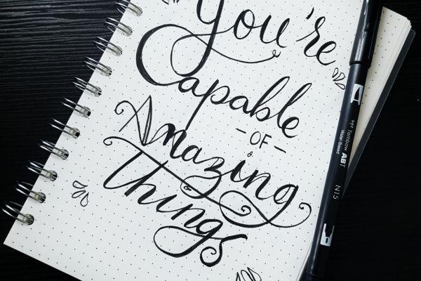 Notebook with written title inside "You are capable of amazing things" in relation to article about why respect is earned not given