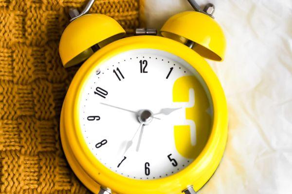a yellow alarm clock remembering you to integrate your daily routine for healthy body and mind and start your day right
