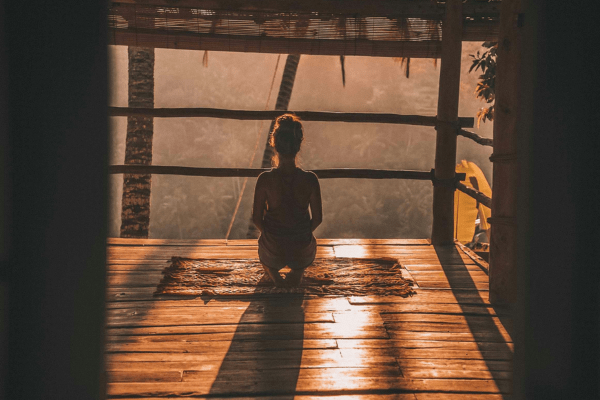 A woman meditating in a beautiful exotic room, on her way for a spiritual awakening journey